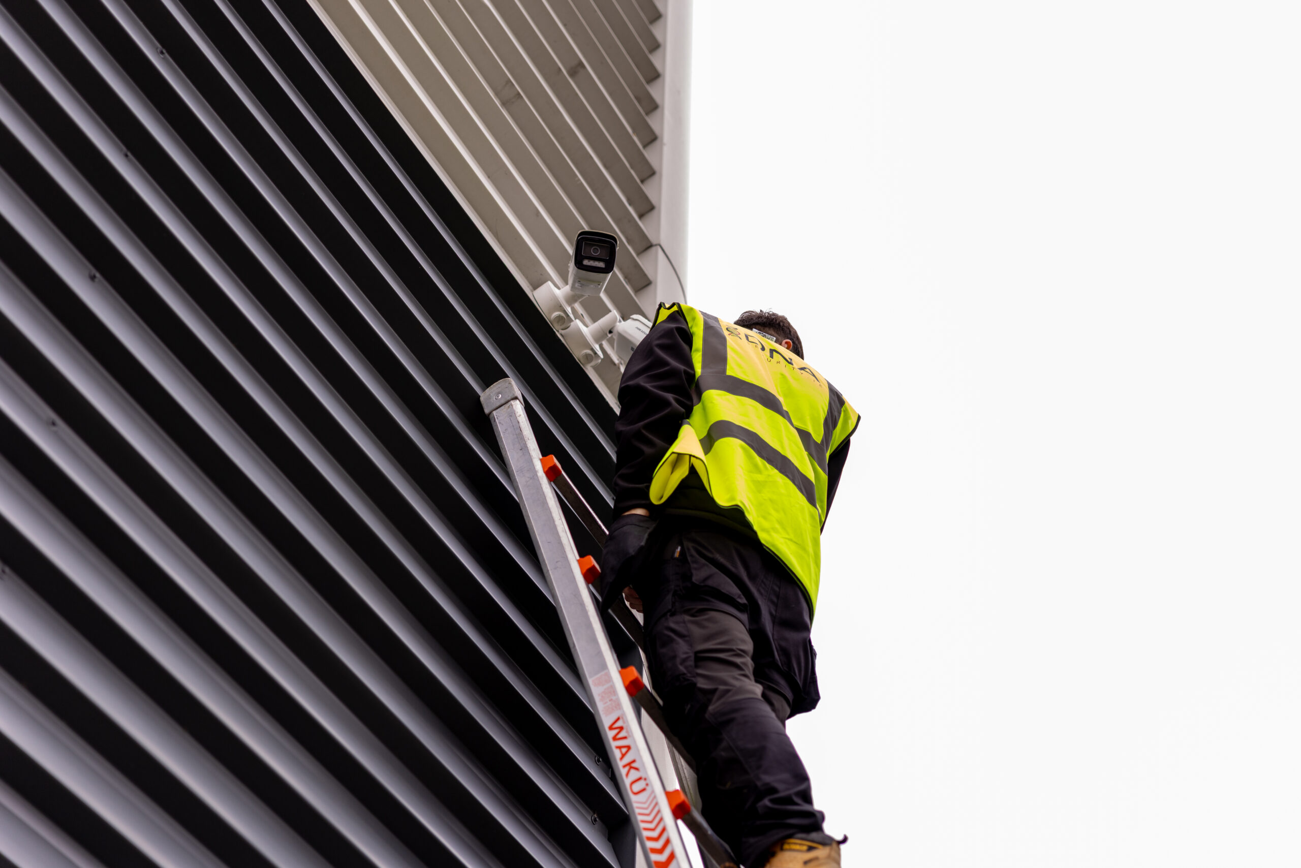 Engineer servicing a commercial CCTV camera
