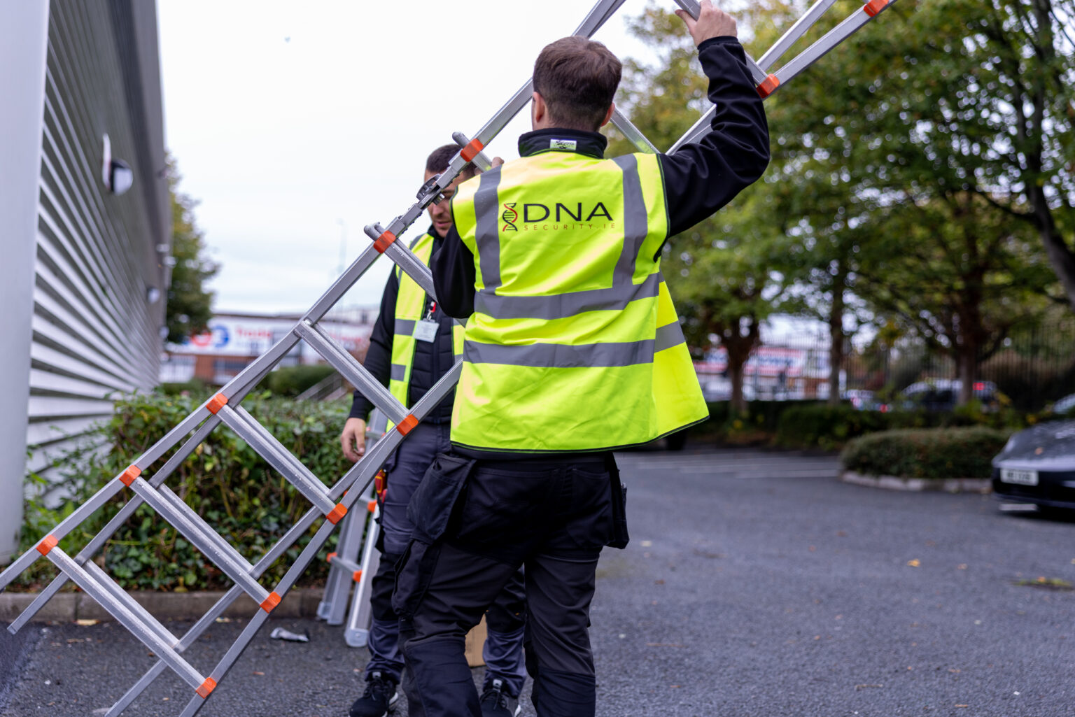 A DNA Security engineer working at height on a customer property in Dublin